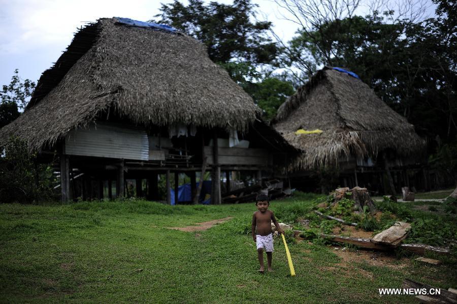 A boy of the Embrea ethnic group plays in front of his house in the Ella Puru Embrea community, outskirts of Panama's capital Panama City, on June 4, 2013.The Embrea and Wounaan indigenous groups are related to the environment through a economy based on agriculture, hunting, fishing and gathering, and now a days with small surplus for trade. The General Assembly of the United Nations (UN), declared June 5 as the World Environment Day. (Xinhua/Mauricio Valenzuela)