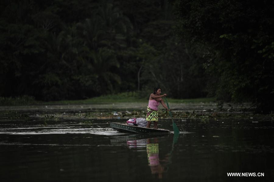 A Woman of the Embrea ethnic group sails on a boat in Lake Gatun in the Ella Puru Embrea community, outskirts of Panama's capital Panama City, on June 4, 2013. The Embrea and Wounaan indigenous groups are related to the environment through a economy based on agriculture, hunting, fishing and gathering, and now a days with small surplus for trade. The General Assembly of the United Nations (UN), declared June 5 as the World Environment Day. (Xinhua/Mauricio Valenzuela)