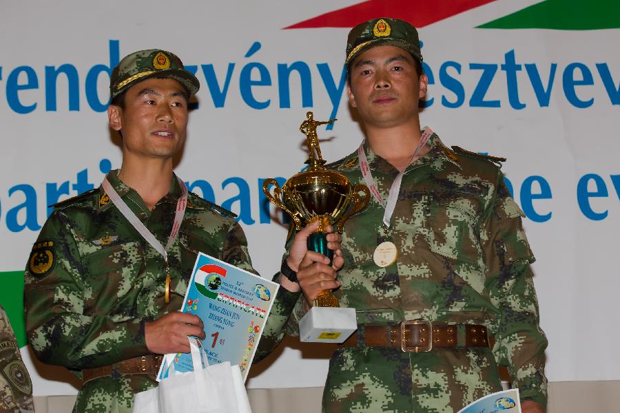 Wang Zhanjun (L) and Zhang Yong of China pose with their trophy during the awarding ceremony at the 12th Police and Military Sniper World Cup in Budapest, Hungary, on June 4, 2013. Wang and Zhang won the gold medal of the Team Military sniper competition of the event. (Xinhua/Attila Volgyi) 