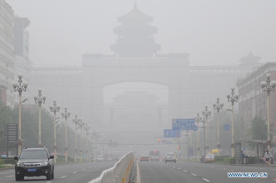 The fog-shrouded Beijing West Railway Station is pictured in Beijing, capital of China, June 5, 2013. Thick fog blanketed the capital city on Wednesday. (Xinhua/Gong Lei)