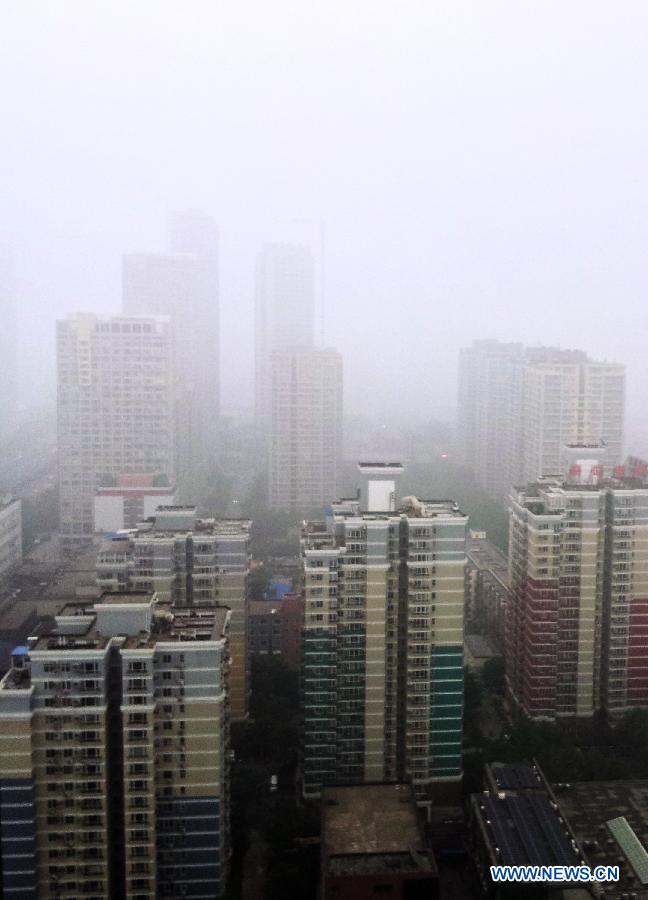 Fog-shrouded buildings are pictured in Beijing, capital of China, June 5, 2013. Thick fog blanketed the capital city on Wednesday. (Xinhua/Li Xin)
