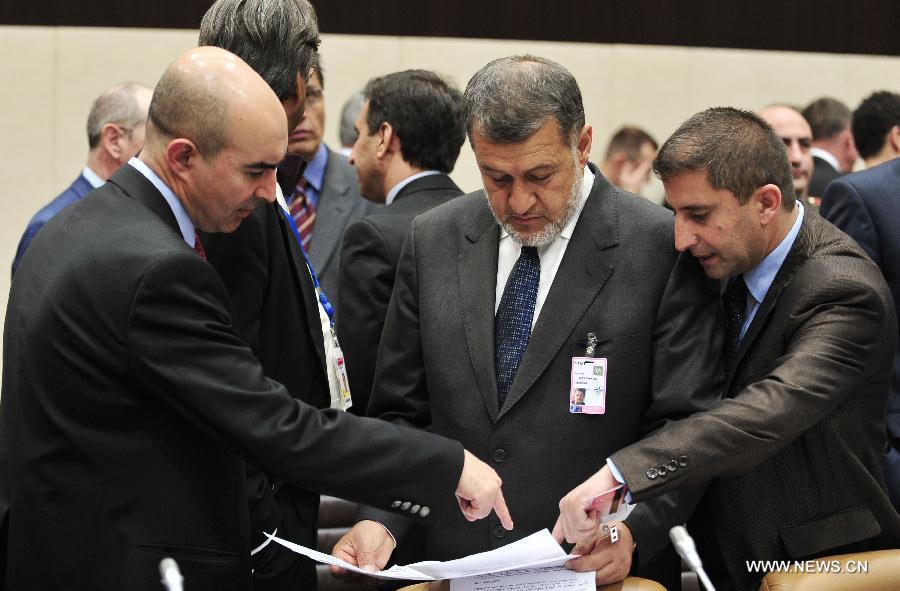Afghan Defence Minister Bismillah Khan Mohammadi (2nd R) reads documents prior to a NATO and non-NATO ISAF contributing nations meeting during two-days NATO Defence Ministers Meeting at its headquarters in Brussels, capital of Belgium, June 5, 2013. (Xinhua/Ye Pingfan)  