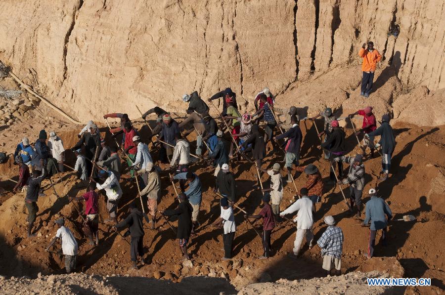 Workers are seen in a sapphire mine in Ilakaka town, the famous sapphire town in southwest Madagascar, on May 31, 2013. Since the discovery of alluvial sapphire deposits in 1998, the population had boomed from 40 residents to near 60,000 by 2005, including many businessmen from Thailand, India, France, China, etc., most of whom dreamed to become rich in one night to find sapphires. Madagsacar, famous for its sapphire production, stood alongside Australia as one of the world's two largest sapphire producers at its peak period. There are still sapphire mines operating around Ilakaka, but most deposits are located deeper below the surface now, and miners have to work much harder to extract sapphires. Due to the deep location and political crisis, Madagascar has not managed to regain its former glory as a primary producer of sapphires. (Xinhua/He Xianfeng)