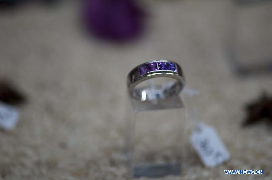 A sapphire product is exhibited in a workshop in Ilakaka town, the famous sapphire town in southwest Madagascar, on May 31, 2013. Since the discovery of alluvial sapphire deposits in 1998, the population had boomed from 40 residents to near 60,000 by 2005, including many businessmen from Thailand, India, France, China, etc., most of whom dreamed to become rich in one night to find sapphires. Madagsacar, famous for its sapphire production, stood alongside Australia as one of the world's two largest sapphire producers at its peak period. There are still sapphire mines operating around Ilakaka, but most deposits are located deeper below the surface now, and miners have to work much harder to extract sapphires. Due to the deep location and political crisis, Madagascar has not managed to regain its former glory as a primary producer of sapphires. (Xinhua/He Xianfeng)