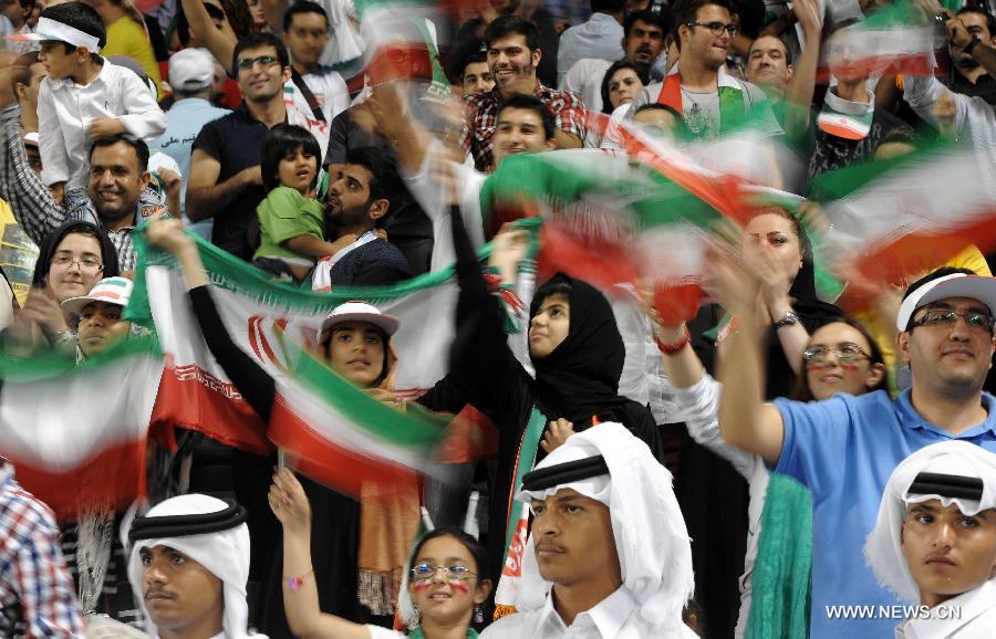 Fans of Iran cheer during the 2014 World Cup qualifying soccer match between Iran and Qatar in Doha, capital of Qatar, June 4, 2013. Iran won 1-0. (Xinhua/Chen Shaojin)