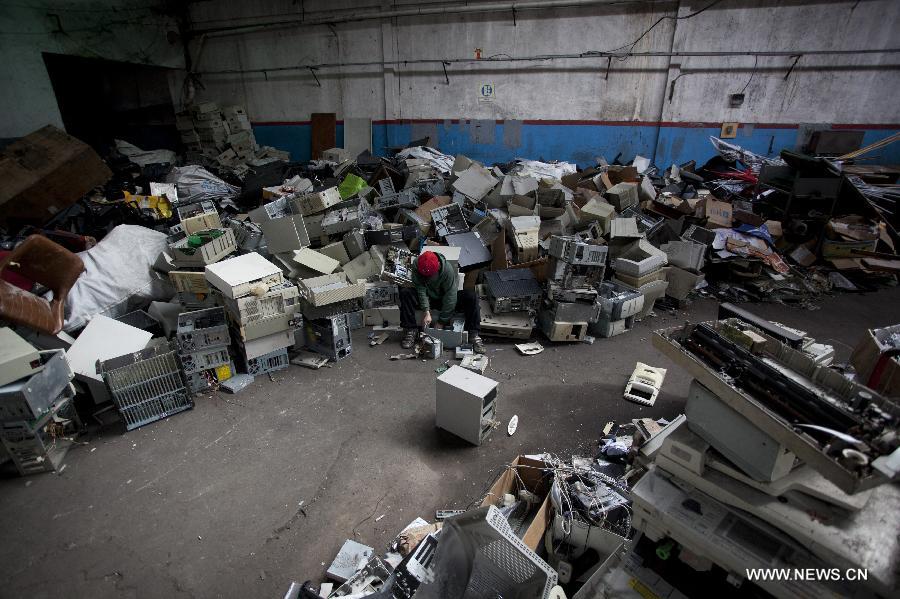 Agustin, a member of the "La Toma" cooperative, that performs electronic waste recycling, works on a CPU during the World Environment Day, in Dock Sud, Argentina, on June 5, 2013. The cooperative, created on 1972, gives work to 20 low-income people, mostly youngsters. The World Environment Day is celebrated yearly on June 5 to create awareness in relation to environmental issues. (Xinhua/Martin Zabala) 