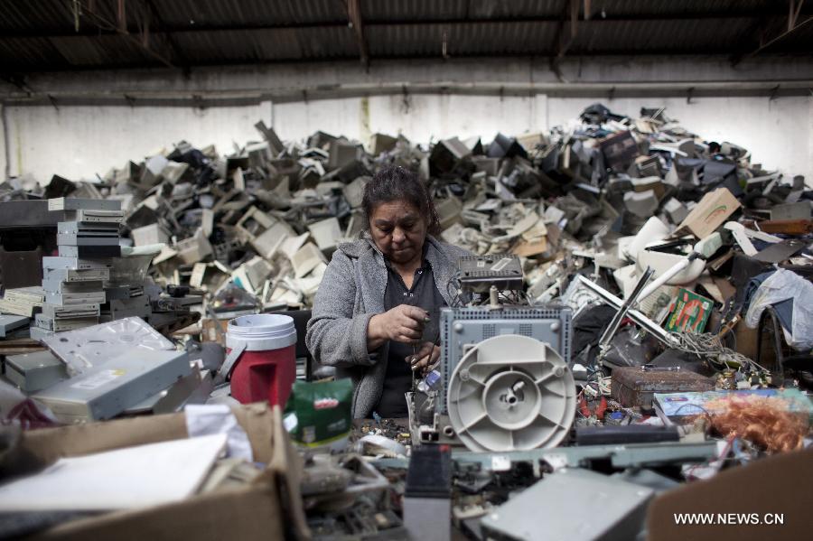 Isabel, one of the founders of the "La Toma" cooperative, that performs electronic waste recycling, works on a computer monitor during the World Environment Day, in Dock Sud, Argentina, on June 5, 2013. The cooperative, created on 1972, gives work to 20 low-income people, mostly youngsters. The World Environment Day is celebrated yearly on June 5 to create awareness in relation to environmental issues. (Xinhua/Martin Zabala) 
