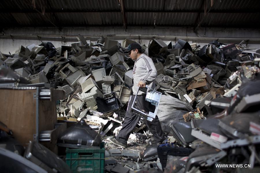 Alejandro, member of the "La Toma" cooperative that performs electronic waste recycling, carries the frame of a disarmed CPU during the World Environment Day, in Dock Sud, Argentina, on June 5, 2013. The cooperative, created on 1972, gives work to 20 low-income people, mostly youngsters. The World Environment Day is celebrated yearly on June 5 to create awareness in relation to environmental issues. (Xinhua/Martin Zabala) 