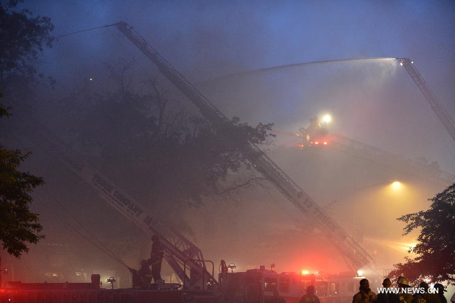 Firefighters work to cease fire at a hardware store on Pennsylvania Avenue SE in Washington, capital of the United States, June 5, 2013. At least two firefighters got wounded in the fire. (Xinhua/Zhang Jun) 