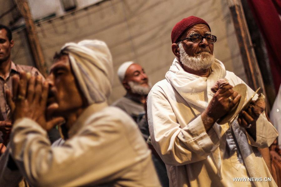 Egyptian Sufi Muslims play Sufi music and perform Sufi dancing during a celebration of the birth anniversary of Sayeda Zainab, who is the granddaughter of Prophet Muhammad, in Cairo, Egypt, June 5, 2013. (Xinhua/Amru Salahuddien)