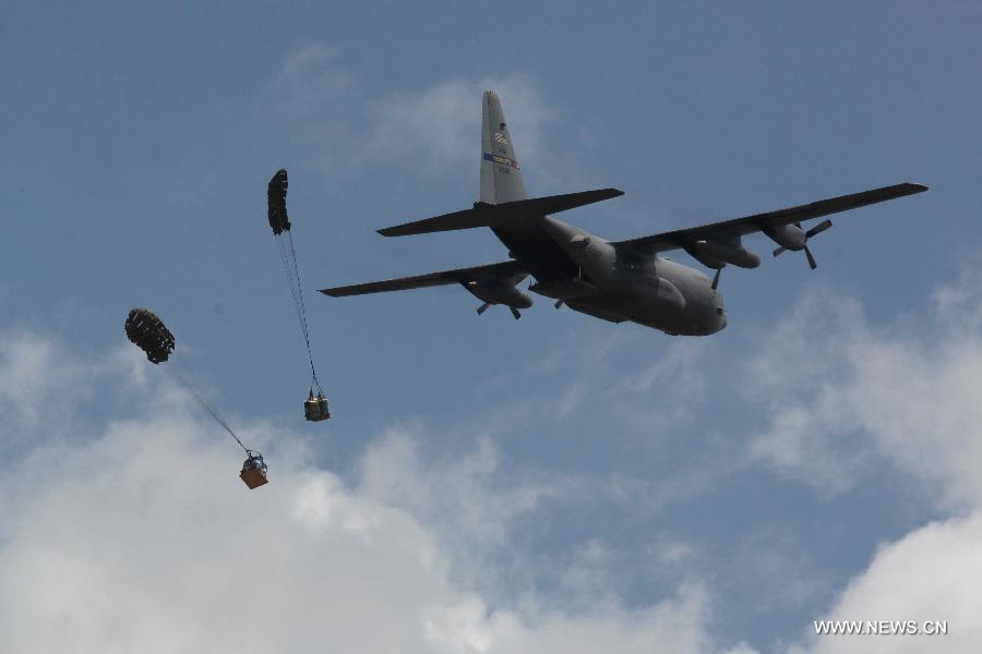 A C-130 aircraft unloads the pallets of relief items during a regional military airlift exercise in Kampong Speu province, Cambodia, June 6, 2013. U.S. and Cambodian Air Forces on Thursday highlighted Pacific Airlift Rally 2013 at Pochentong Air Base with a humanitarian assistance and air drop simulation, said a media statement from the U.S. Embassy in Cambodia. (Xinhua/Sovannara)