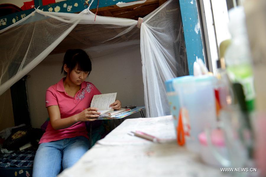 A student prepares for the national college entrance exam in her dorm room at the Jinzhai No. 1 Senior High School in Liuan, east China's Anhui Province, June 5, 2013. The annual national college entrance exam will take place on June 7 and 8. Some 9.12 million applicants are expected to sit this year's college entrance exam, down from 9.15 million in 2012, according to the Ministry of Education (MOE). (Xinhua/Zhang Duan) 