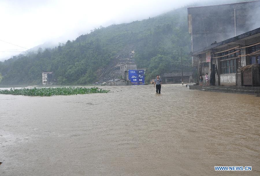A man walks in the flooded Xiaba Village in Gaoluo Township, Xuan'en County, Enshi Tujia and Miao Autonomous Prefecture of central China's Hubei Province, June 6, 2013. Torrential rainfall made parts of Enshi flooded on Thursday morning, and a total of 513 residents have been evacuated. (Xinhua)