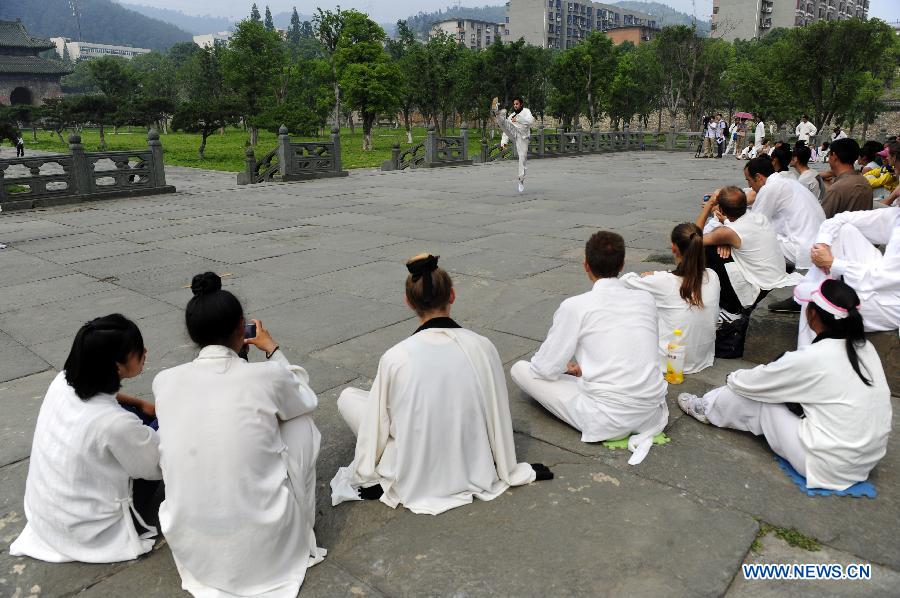 A foreign learner practises Chinese martial arts movements at the Yuxu Palace on Wudang Mountain, known as a traditional center for the teaching and practice of martial arts, in central China's Hubei Province, June 5, 2013. (Xinhua/Hao Tongqian) 