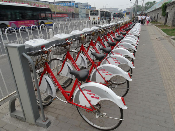 Public rental bikes stand idle in Qianmen, Beijing, June 3, 2013. 