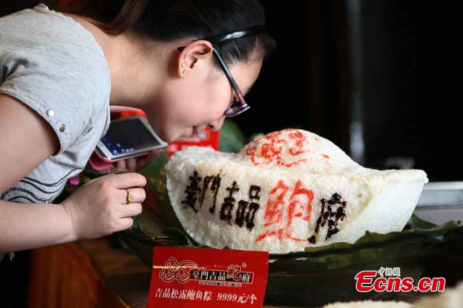 A luxury zongzi priced at 9,999 yuan (US$1,620) is displayed in a restaurant in Taiyuan, capital of Shanxi Province, June 6, 2013. The zongzi is made of sticky rice with rare stuffing, including abalone, black truffles and jamón. Zongzi has been a traditional food in China for a long time at Duanwu Festival, the fifth of May on Chinese lunar calendar which fall on June 12 this year. (CNS/Zhang Yun)