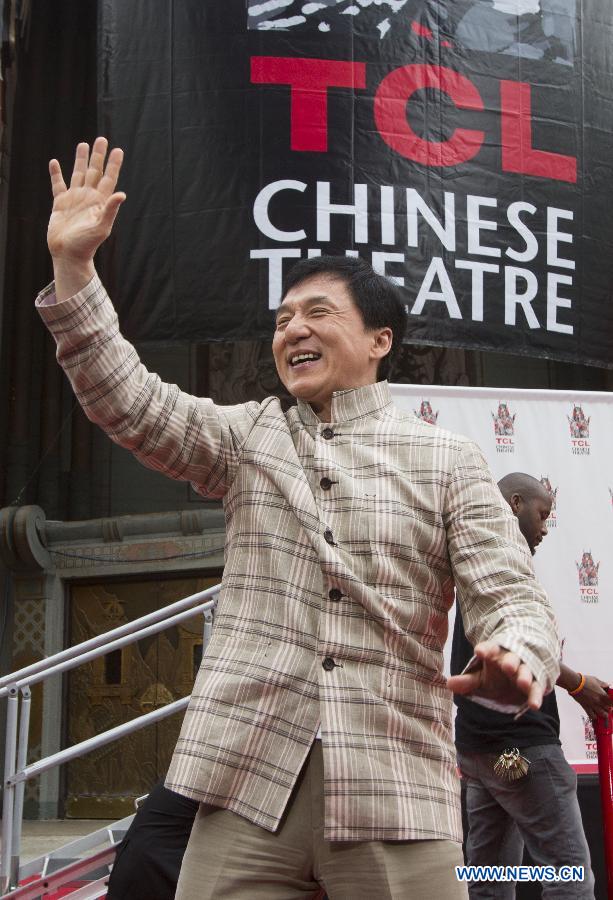 Actor Jackie Chan waves at his hand and footprint ceremony in front of the TCL Chinese Theatre in Hollywood, California on June 6, 2013. (Xinhua/Zhao Hanrong) 