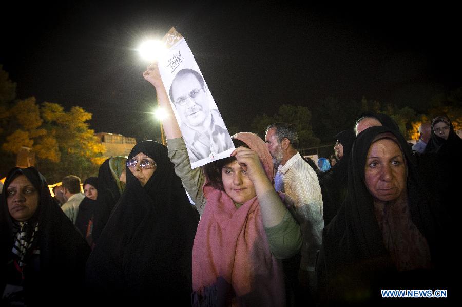 An Iranian girl holds a poster of Tehran Mayor and presidential candidate Mohammad-Baqer Qalibaf during a campaign rally in Shahr-e Rey, south of Tehran, Iran, on June 7, 2013. Iran's 11th presidential election is scheduled for June 14. (Xinhua/Ahmad Halabisaz) 