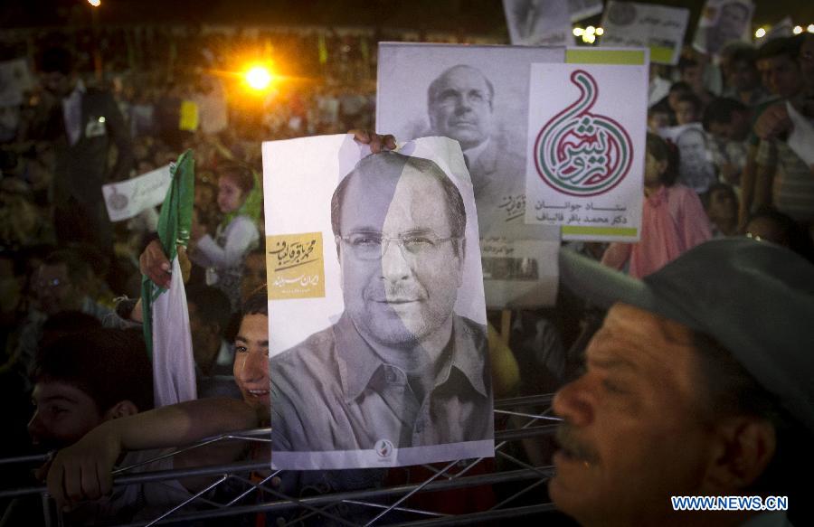 Supporters hold up posters of Tehran Mayor and presidential candidate Mohammad-Baqer Qalibaf during a campaign rally in Shahr-e Rey, south of Tehran, Iran, on June 7, 2013. Iran's 11th presidential election is scheduled for June 14. (Xinhua/Ahmad Halabisaz) 