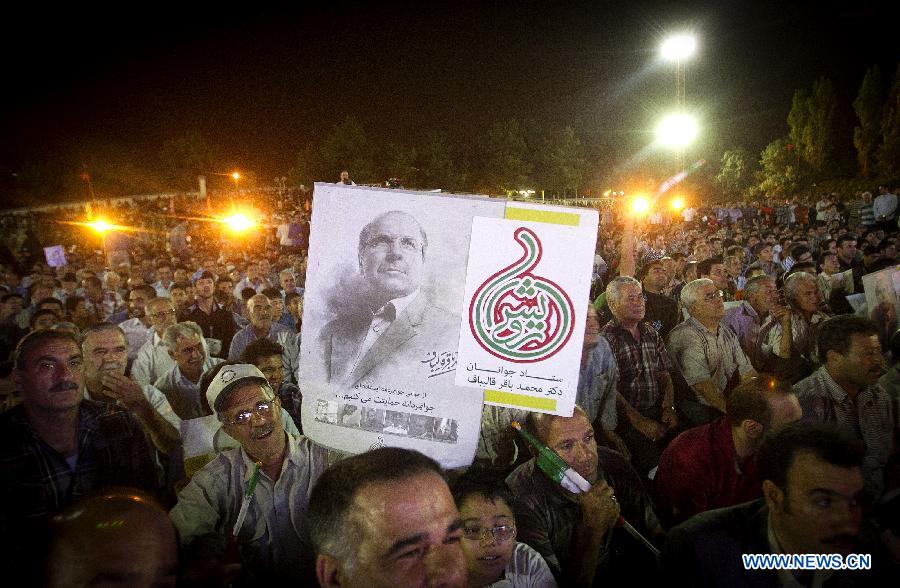 Supporters hold up posters of Tehran Mayor and presidential candidate Mohammad-Baqer Qalibaf during a campaign rally in Shahr-e Rey, south of Tehran, Iran, on June 7, 2013. Iran's 11th presidential election is scheduled for June 14. (Xinhua/Ahmad Halabisaz) 