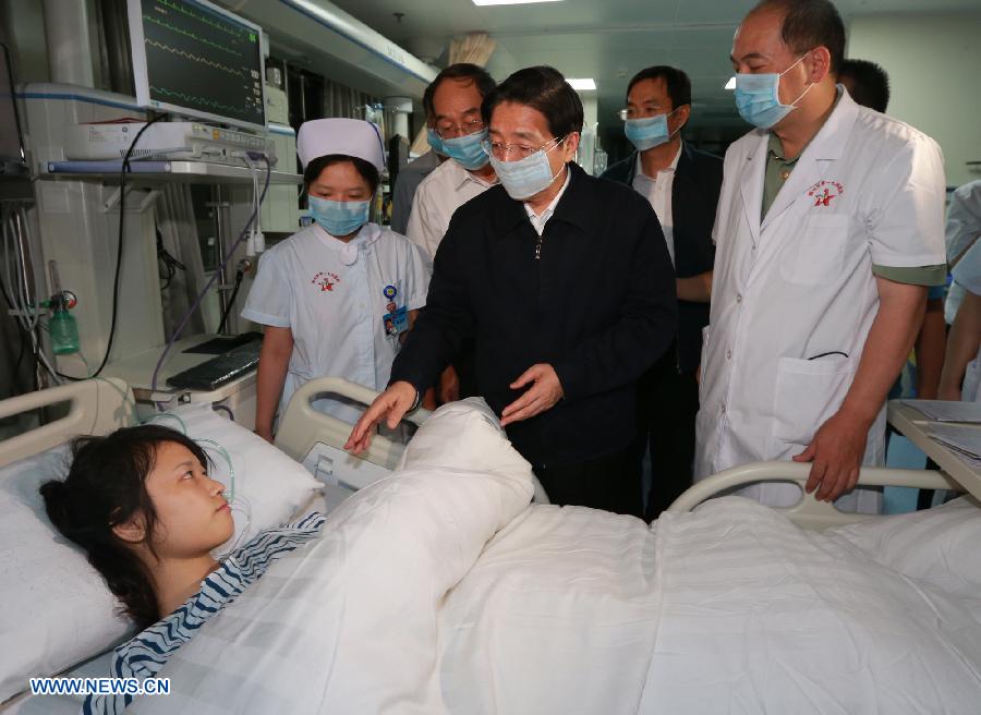 Chinese State Councilor and Public Security Minister Guo Shengkun (C) comforts an injured passenger in a hospital in Xiamen, capital of southeast China's Fujian Province, June 8, 2013. The State Council, China's cabinet, has sent a work team led by Guo to Xiamen to oversee the investigation of the bus fire that has claimed 47 lives and hospitalized 34 on Friday evening. (Xinhua/Zhang Jianxin) 