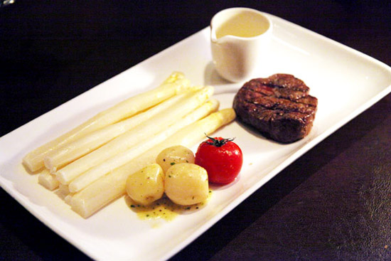 Slow-cooked white asparagus with butter-glazed potatoes and Australian beef. (China Daily/Fan Zhen)