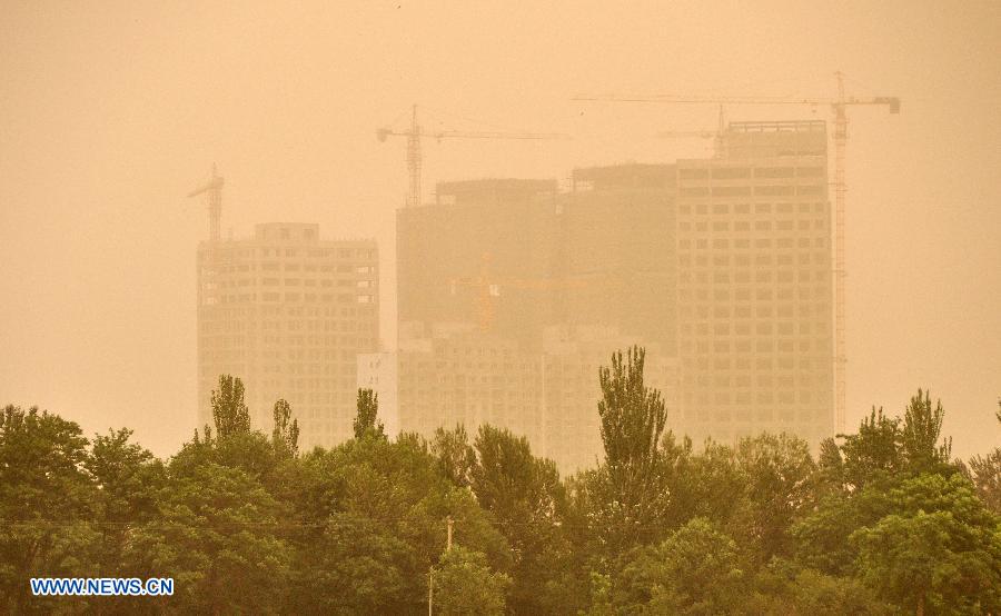 The city is seen enveloped in heavy sand storm in Yinchuan, capital of northwest China's Ningxia Hui Autonomous Region, June 8, 2013. (Xinhua/Wang Peng)