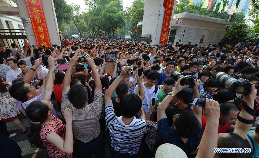 Students walk out of the exam site after the college entrance examination in the No. 1 Middle School in Changsha, capital of central China's Hunan Province, June 8, 2013. The 2013 national college entrance examination ended in some regions of China on Saturday. Approximately 9.12 million people took part in the exam this year. (Xinhua/Bai Yu)
