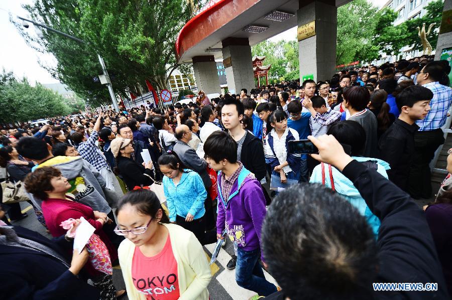 Students walk out of the exam site in Hutai Middle School in Xining, northwest China's Qinghai Province, June 8, 2013. The 2013 national college entrance examination ended in some regions of China on Saturday. Approximately 9.12 million people took part in the exam this year. (Xinhua/Wu Gang)