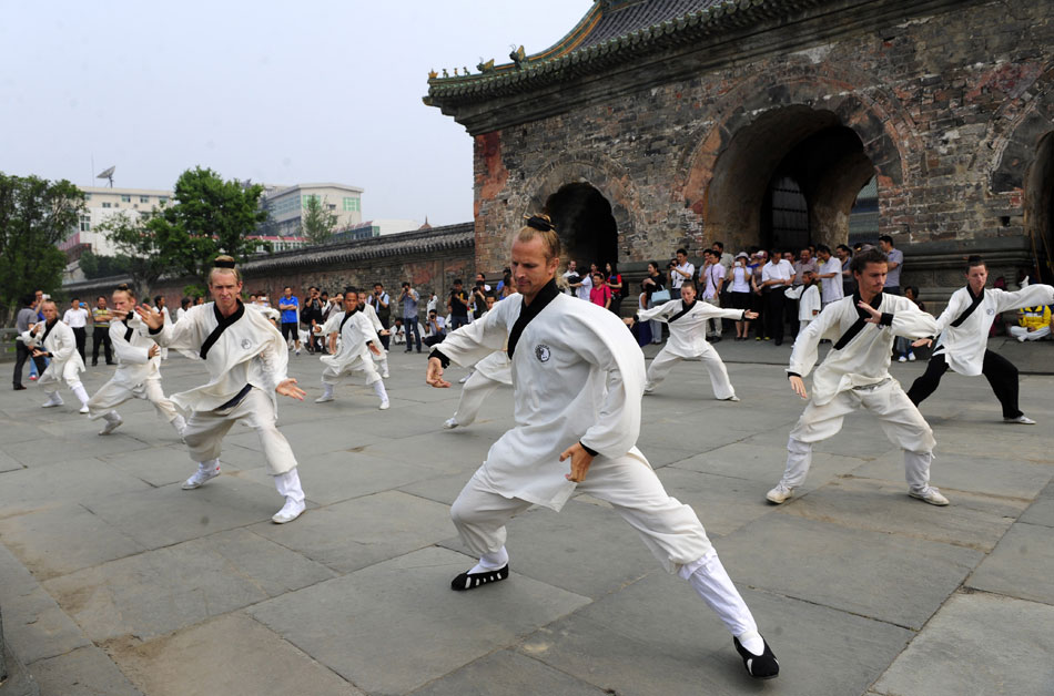 Foreign learners practise Chinese martial arts movements at the Yuxu Palace on Wudang Mountain, known as a traditional center for the teaching and practice of martial arts, in central China's Hubei province, June 5, 2013. (Xinhua/Hao Tongqian)