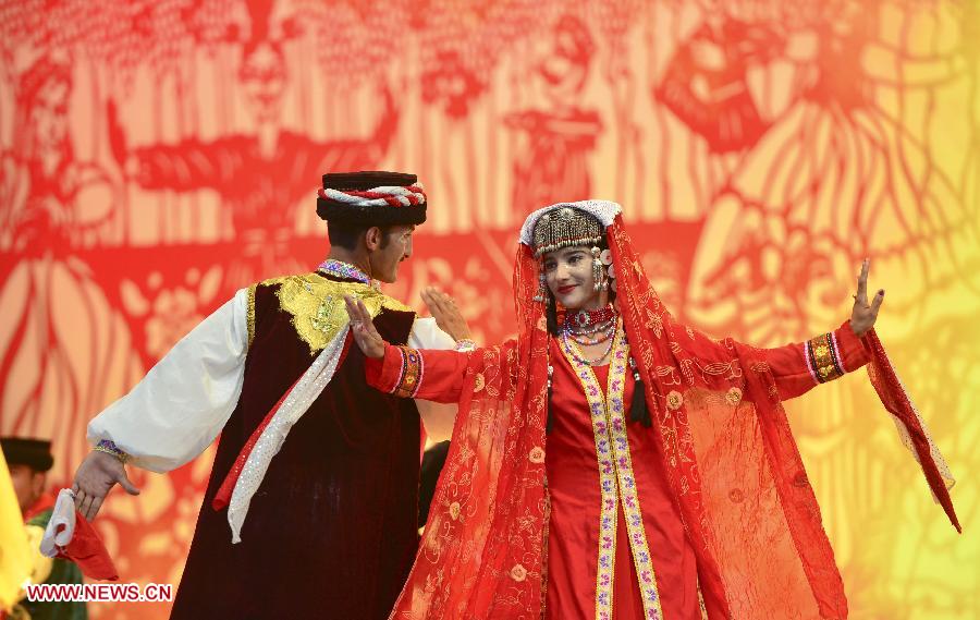 People perform dance during an activity to display local intangible cultural heritage in Changji, northwest China's Xinjiang Uygur Autonomous Region, June 8, 2013. (Xinhua/Jiang Wenyao)