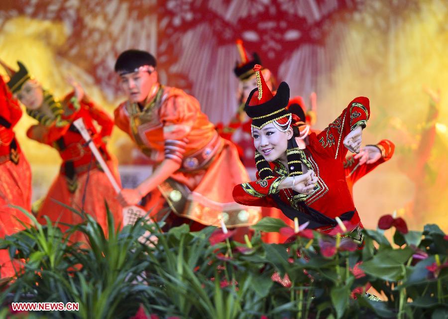 People perform dance during an activity to display local intangible cultural heritage in Changji, northwest China's Xinjiang Uygur Autonomous Region, June 8, 2013. (Xinhua/Jiang Wenyao)