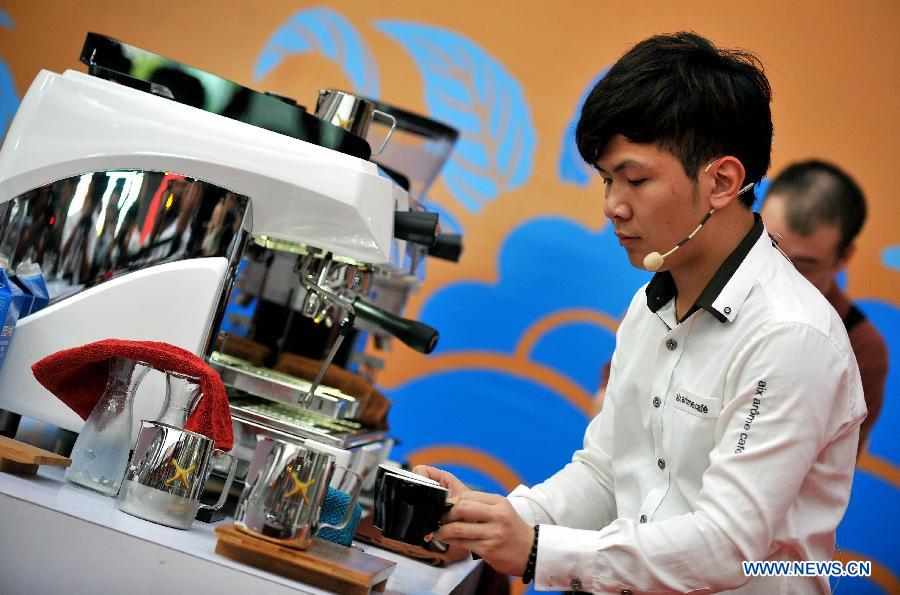 A barista competes during the 2nd Fushan Cup international Barista Championship of China in Chengmai, south China's Hainan Province, June 9, 2013. A total of 24 baristas around the world participated in the championship. (Xinhua/Guo Cheng)