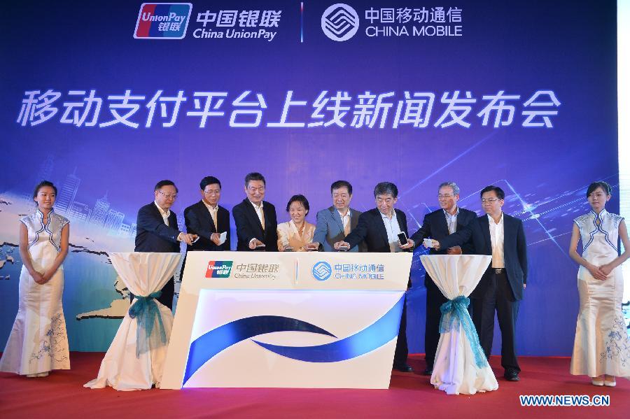 Delegates attend a press conference to launch the mobile payment platform in Beijing, capital of China, June 9, 2013. China's UnionPay bank card network established the mobile payment platform with telecom operator China Mobile, according to a press conference on Sunday. (Xinhua/Li Xin) 