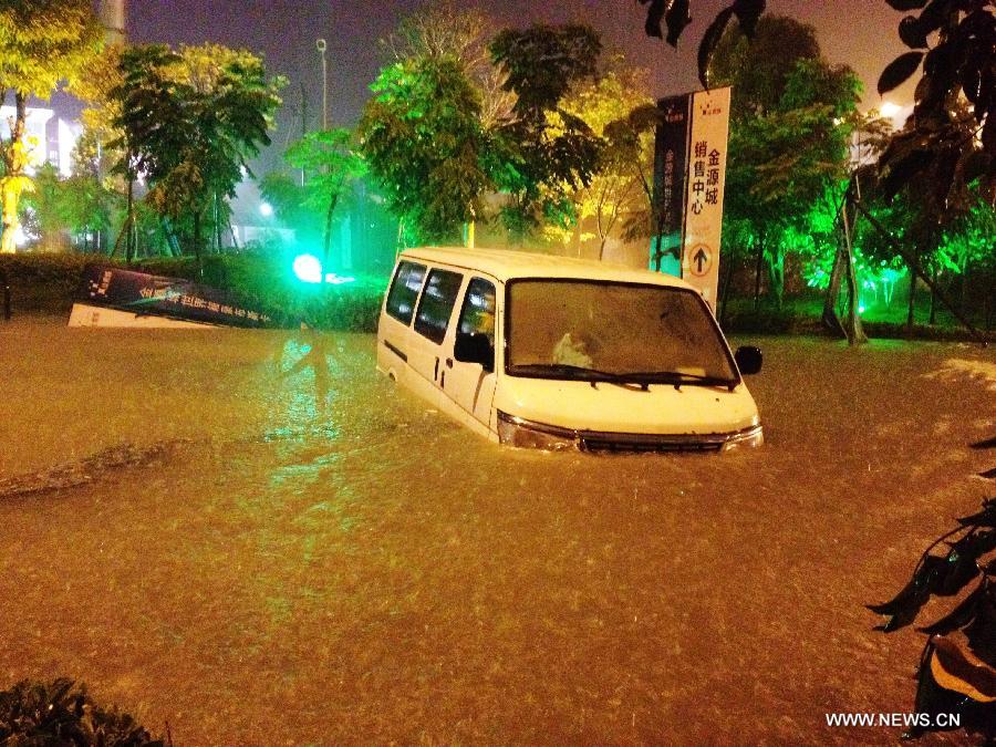 A microbus is submerged in the flood water at a community in Nanning City, capital of south China's Guangxi Zhuang Autonomous Region June 9, 2013. A thunder storm hit Nanning Sunday night, causing floods in many regions of the city. (Xinhua/Xiang Zhiqiang) 