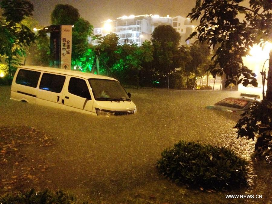 A microbus is submerged in the flood water at a community in Nanning City, capital of south China's Guangxi Zhuang Autonomous Region June 9, 2013. A thunder storm hit Nanning Sunday night, causing floods in many regions of the city. (Xinhua/Xiang Zhiqiang) 