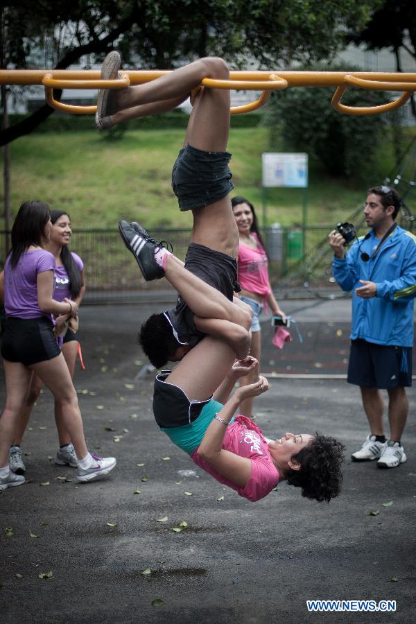Women practise pole dance on the Pole Dance National Day at a park in Mexico City, capital of Mexico, June 9, 2013. Mexican women gathered in parks around the country to practise pole dance June 9, the third Pole Dance National Day, or the Urban Pole National Day. The pole dance, practised as a sports event, has become popular among Mexican women. (Xinhua/Pedro Mera)
