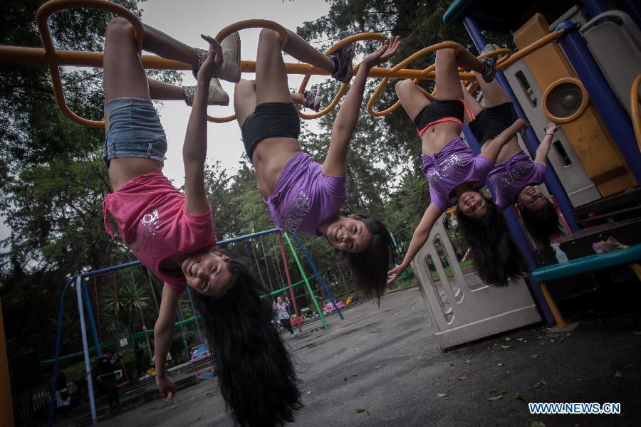 Women practise pole dance on the Pole Dance National Day at a park in Mexico City, capital of Mexico, June 9, 2013. Mexican women gathered in parks around the country to practise pole dance June 9, the third Pole Dance National Day, or the Urban Pole National Day. The pole dance, practised as a sports event, has become popular among Mexican women. (Xinhua/Pedro Mera)