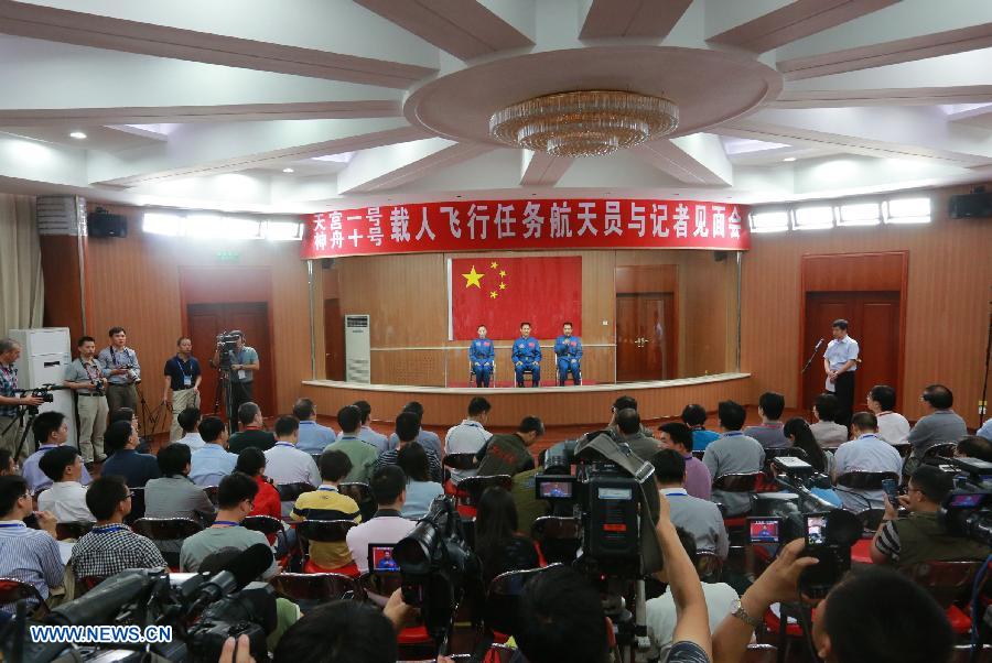 The three astronauts of the Shenzhou-10 manned spacecraft mission, Nie Haisheng (C), Zhang Xiaoguang (R) and Wang Yaping, meet the media at the Jiuquan Satellite Launch Center in Jiuquan, northwest China's Gansu Province, June 10, 2013. The Shenzhou-10 manned spacecraft will be launched at the Jiuquan Satellite Launch Center at 5:38 p.m. Beijing Time (0938 GMT) June 11. (Xinhua/Wang Jianmin)