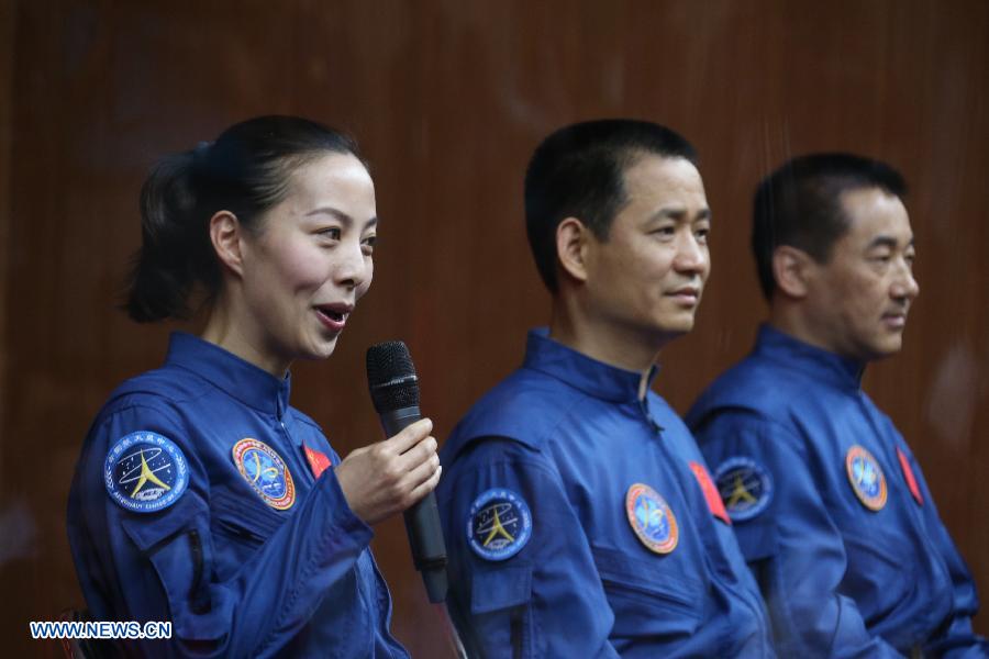 Wang Yaping (L), one of the three astronauts of the Shenzhou-10 manned spacecraft mission, answers a question as meeting the media at the Jiuquan Satellite Launch Center in Jiuquan, northwest China's Gansu Province, June 10, 2013. The Shenzhou-10 manned spacecraft will be launched at the Jiuquan Satellite Launch Center at 5:38 p.m. Beijing Time (0938 GMT) June 11. (Xinhua/Wang Jianmin)
