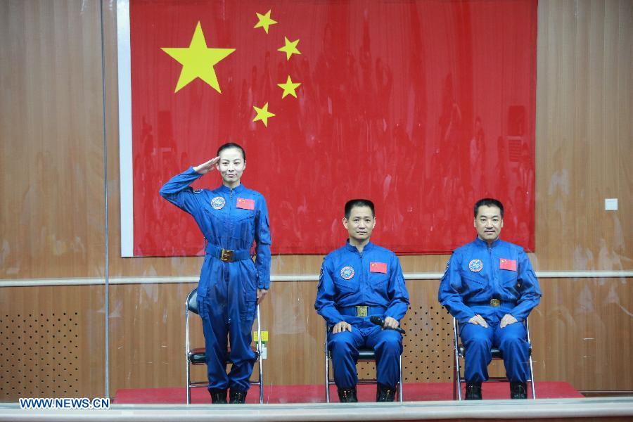 The three astronauts of the Shenzhou-10 manned spacecraft mission, Nie Haisheng (C), Zhang Xiaoguang (R) and Wang Yaping, meet the media at the Jiuquan Satellite Launch Center in Jiuquan, northwest China's Gansu Province, June 10, 2013. The Shenzhou-10 manned spacecraft will be launched at the Jiuquan Satellite Launch Center at 5:38 p.m. Beijing Time (0938 GMT) June 11. (Xinhua/Li Gang)