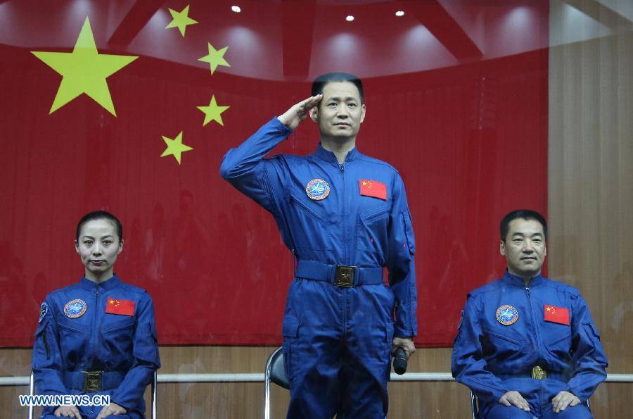 The three astronauts of the Shenzhou-10 manned spacecraft mission, Nie Haisheng (C), Zhang Xiaoguang (R) and Wang Yaping, meet the media at the Jiuquan Satellite Launch Center in Jiuquan, northwest China's Gansu Province, June 10, 2013. The Shenzhou-10 manned spacecraft will be launched at the Jiuquan Satellite Launch Center at 5:38 p.m. Beijing Time (0938 GMT) June 11. (Xinhua/Li Gang)