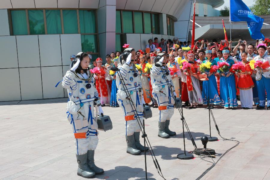 Astronauts Nie Haisheng (C), Zhang Xiaoguang (R) and Wang Yaping attend the setting-out ceremony of the manned Shenzhou-10 mission at the Jiuquan Satellite Launch Center in Jiuquan, northwest China's Gansu Province, June 11, 2013. (Xinhua/Li Gang) 