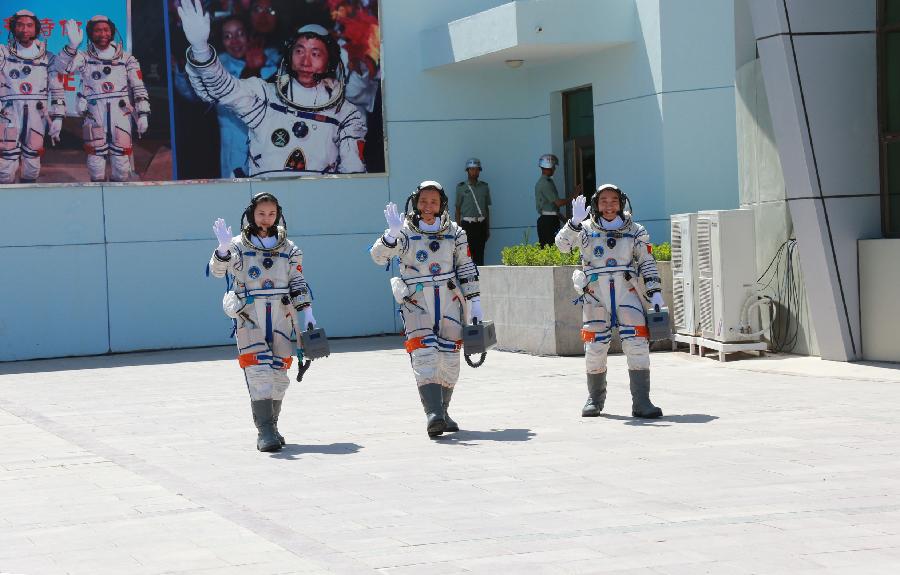 Astronauts Nie Haisheng (C), Zhang Xiaoguang (R) and Wang Yaping attend the setting-out ceremony of the manned Shenzhou-10 mission at the Jiuquan Satellite Launch Center in Jiuquan, northwest China's Gansu Province, June 11, 2013. (Xinhua/Li Gang)
