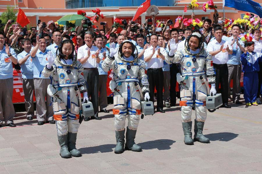 Astronauts Nie Haisheng (R), Zhang Xiaoguang (C) and Wang Yaping attend the setting-out ceremony of the manned Shenzhou-10 mission at the Jiuquan Satellite Launch Center in Jiuquan, northwest China's Gansu Province, June 11, 2013. (Xinhua/Li Gang) 