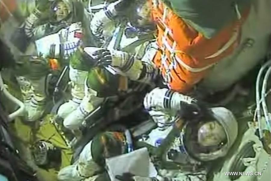 Astronauts inside Shenzhou-10 spacecraft while launching