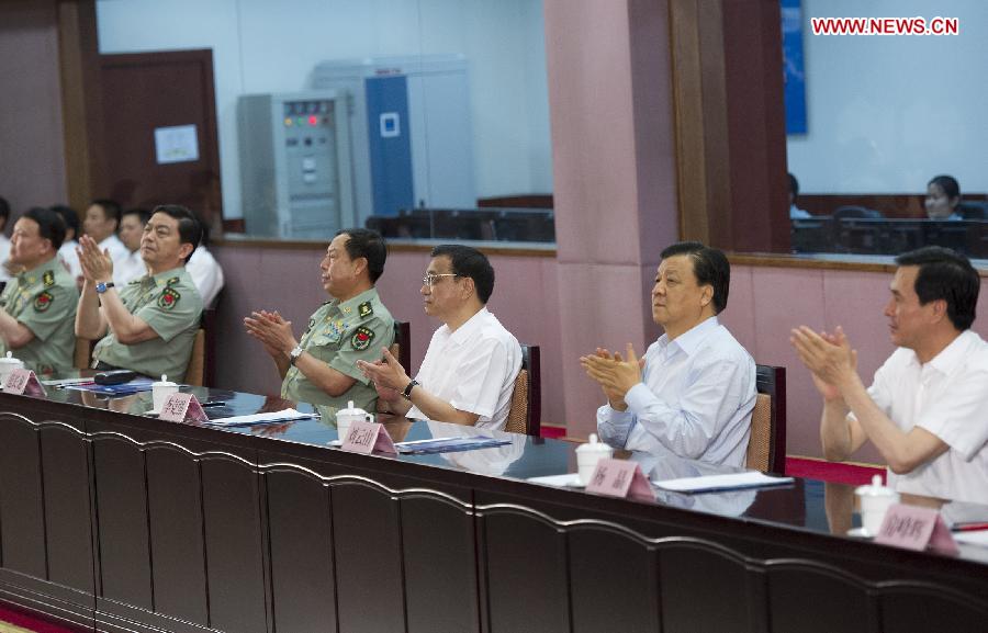 Chinese Premier Li Keqiang (3rd R) and Liu Yunshan (2nd R), a member of the Standing Committee of the Political Bureau of the Communist Party of China Central Committee, watch a live broadcast of the launch of the manned Shenzhou-10 spacecraft at the Beijing Aerospace Control Center in Beijing, capital of China, June 11, 2013. (Xinhua/Huang Jingwen) 