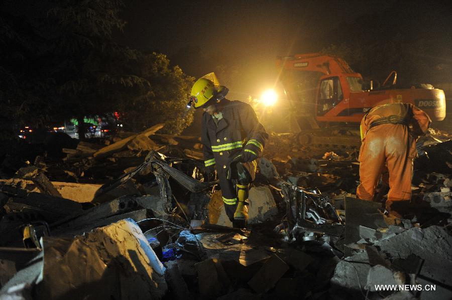 Rescuers look for victims at the accident site after an explosion toppled a three-story building in Suzhou City, east China's Jiangsu Province, June 11, 2013. Twenty people who were buried following an explosion of the staff canteen had been found. Eleven of them died in hospital, while the remaining nine are still receiving treatment in two local hospitals, according to the press briefing. A preliminary investigation showed that the blast was caused by a gas leak. (Xinhua/Shen Peng)
