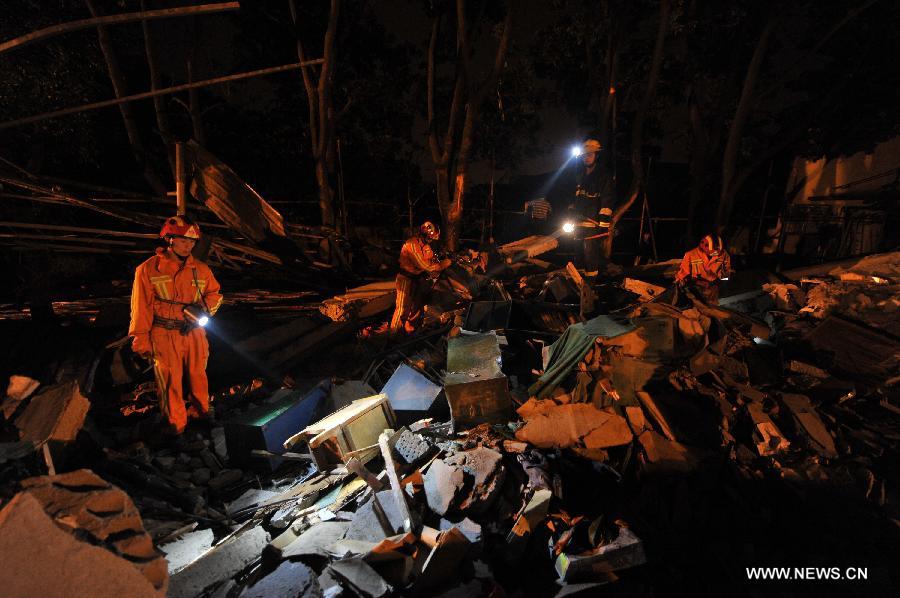 Rescuers look for victims at the accident site after an explosion toppled a three-story building in Suzhou City, east China's Jiangsu Province, June 11, 2013. Twenty people who were buried following an explosion of the staff canteen had been found. Eleven of them died in hospital, while the remaining nine are still receiving treatment in two local hospitals, according to the press briefing. A preliminary investigation showed that the blast was caused by a gas leak. (Xinhua/Shen Peng)