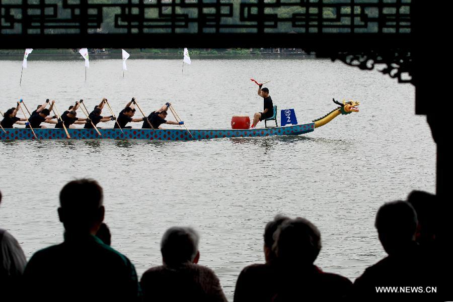 Participants compete in a boat race held to mark the annual Dragon Boat Festival on the Mochou Lake, Nanjing, east China's Jiangsu Province, June 10, 2013. This year's Dragon Boat Festival falls on June 12. (Xinhua/Xu Yijia)